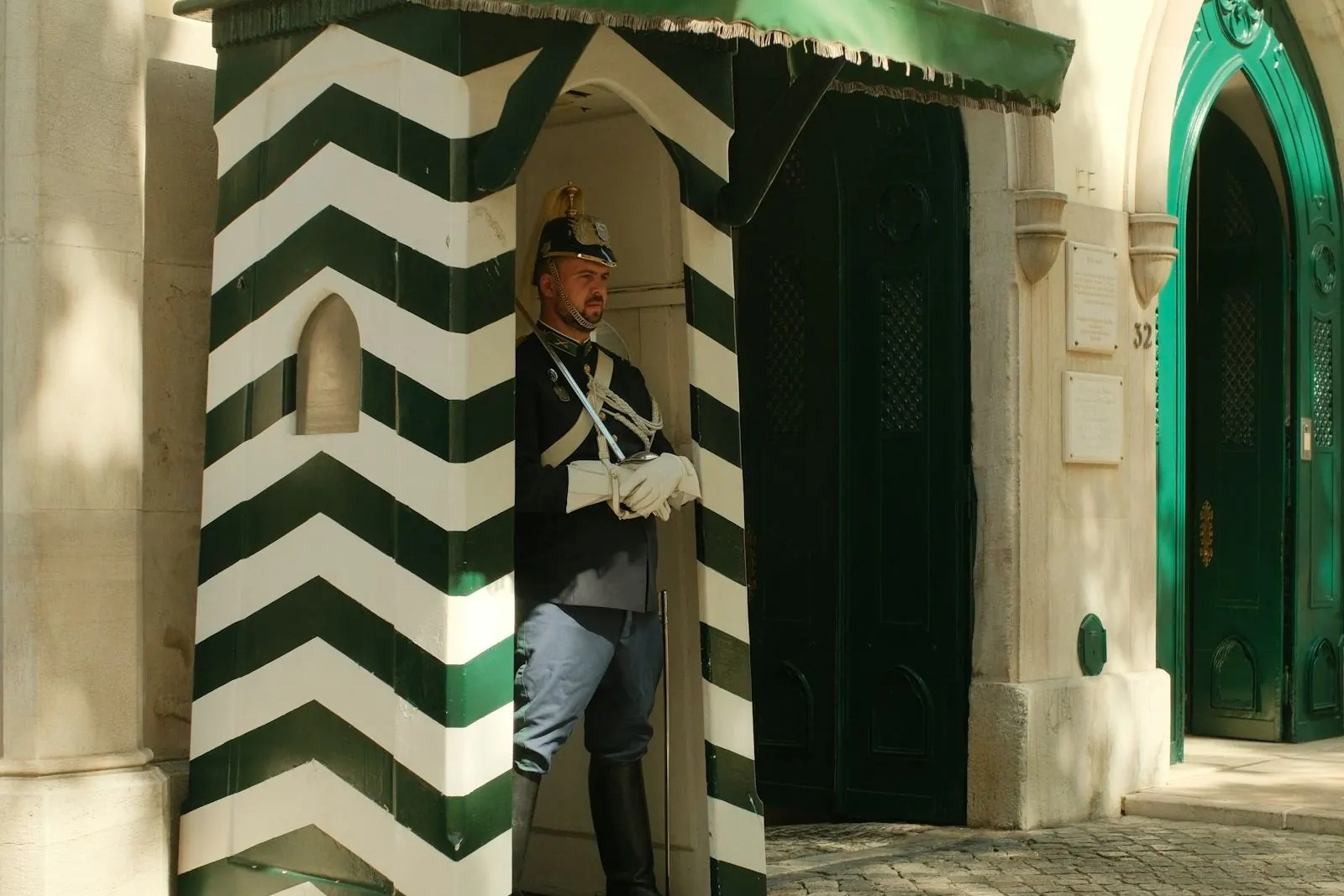 A GNR guard of honour at a green and white striped sentry box in Largo do Carmo, Lisbon